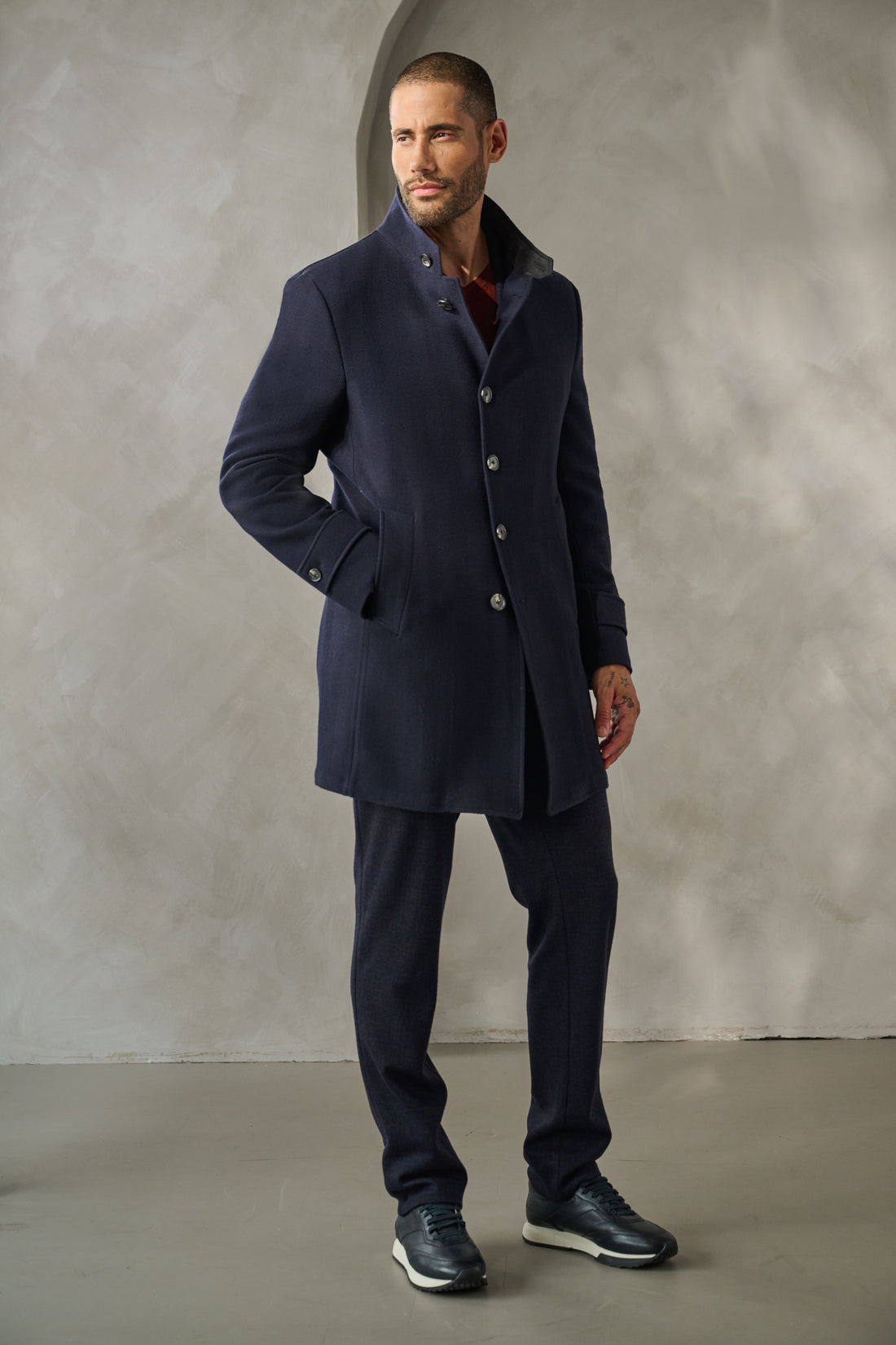 This modern car coat is designed to serve you well in the city: whether driving or walking, this coat offers luxe hybrid design tailored to reflect the scope of men's style today.  With its subtle navy herringbone pattern, and details such as the suede inside collar, you will love this new coat - a perfect blend of style and function.
